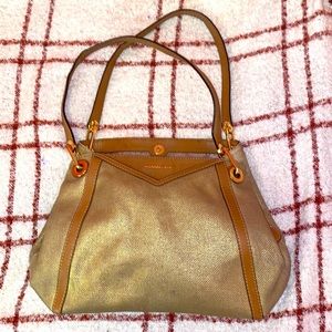 Gold metallic cotton canvas. Easy to carry and maintain. Fairly new shoulder bag